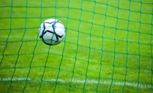 Soccer ball flying in the net.
