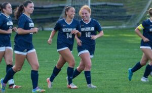 Needham's Michelle Faynstein (14) celebrates her second goal of the game with Jessica Brayer (18). (Patrick Donnelly/NESJ)