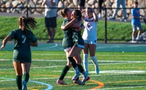 Michaela Poidomani (right) and Savannah Ryan (left) celebrate Poidomani's goal against Wellesley. (Patrick Donnelly/NESJ)
