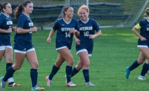 Needham's Michelle Faynstein (14) celebrates a goal earlier this season with Jessica Brayer (18). (Patrick Donnelly/NESJ)